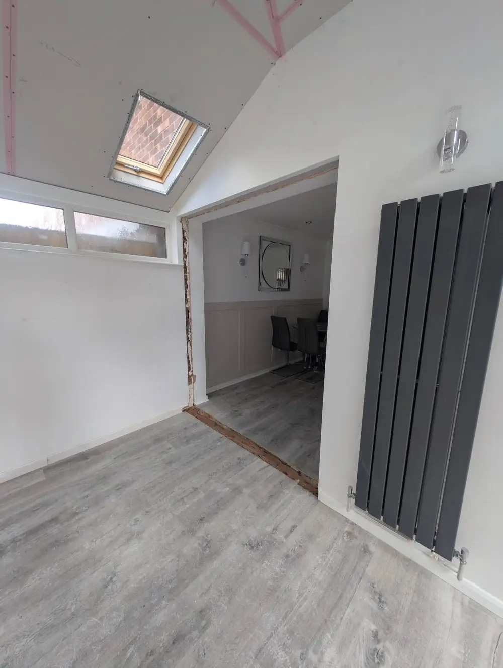Inside a converted conservatory, plastered with skylights