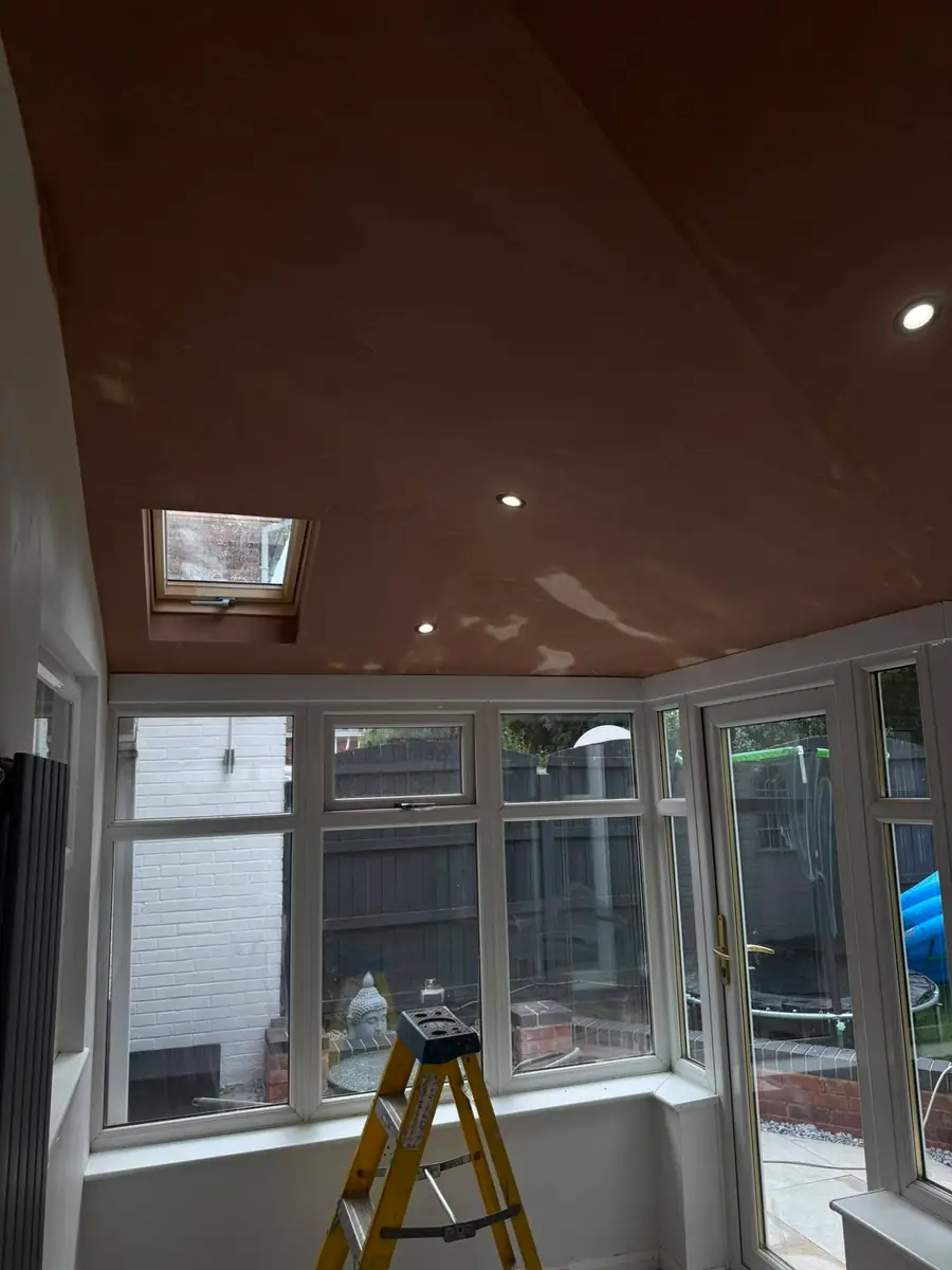 Plastered conservatory ceiling with downlights fitted and lit