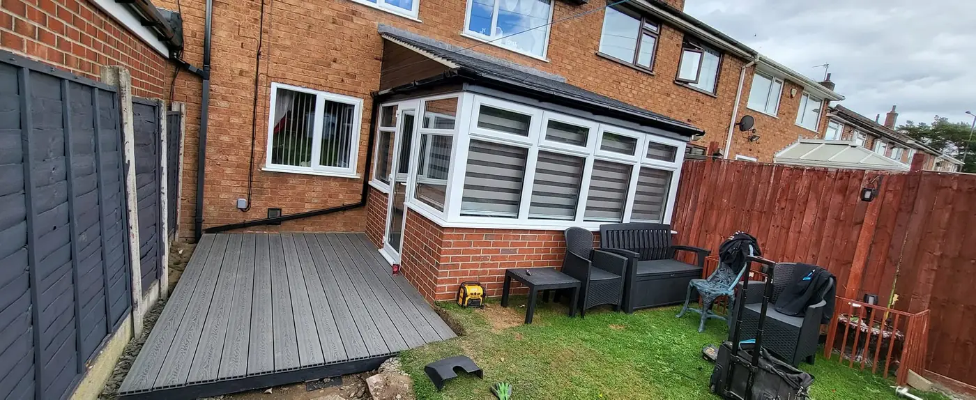 Rear of a house with conservatory and new decking