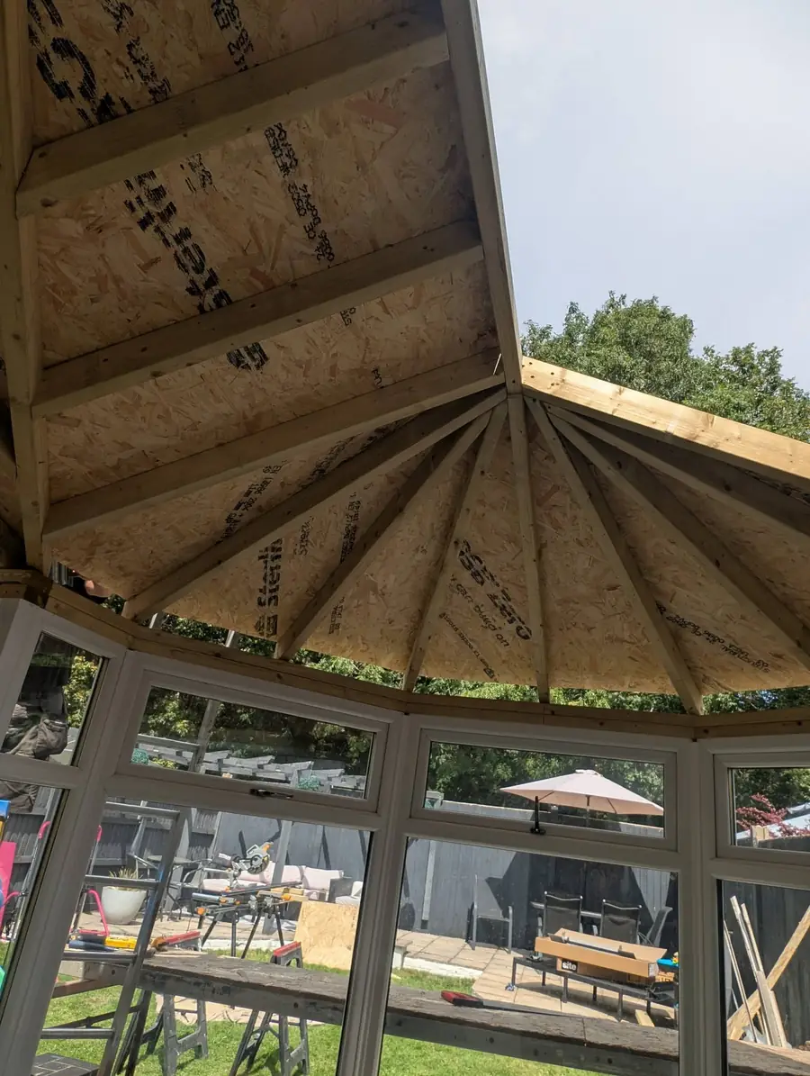 New timber roof structure fanning out over a bay