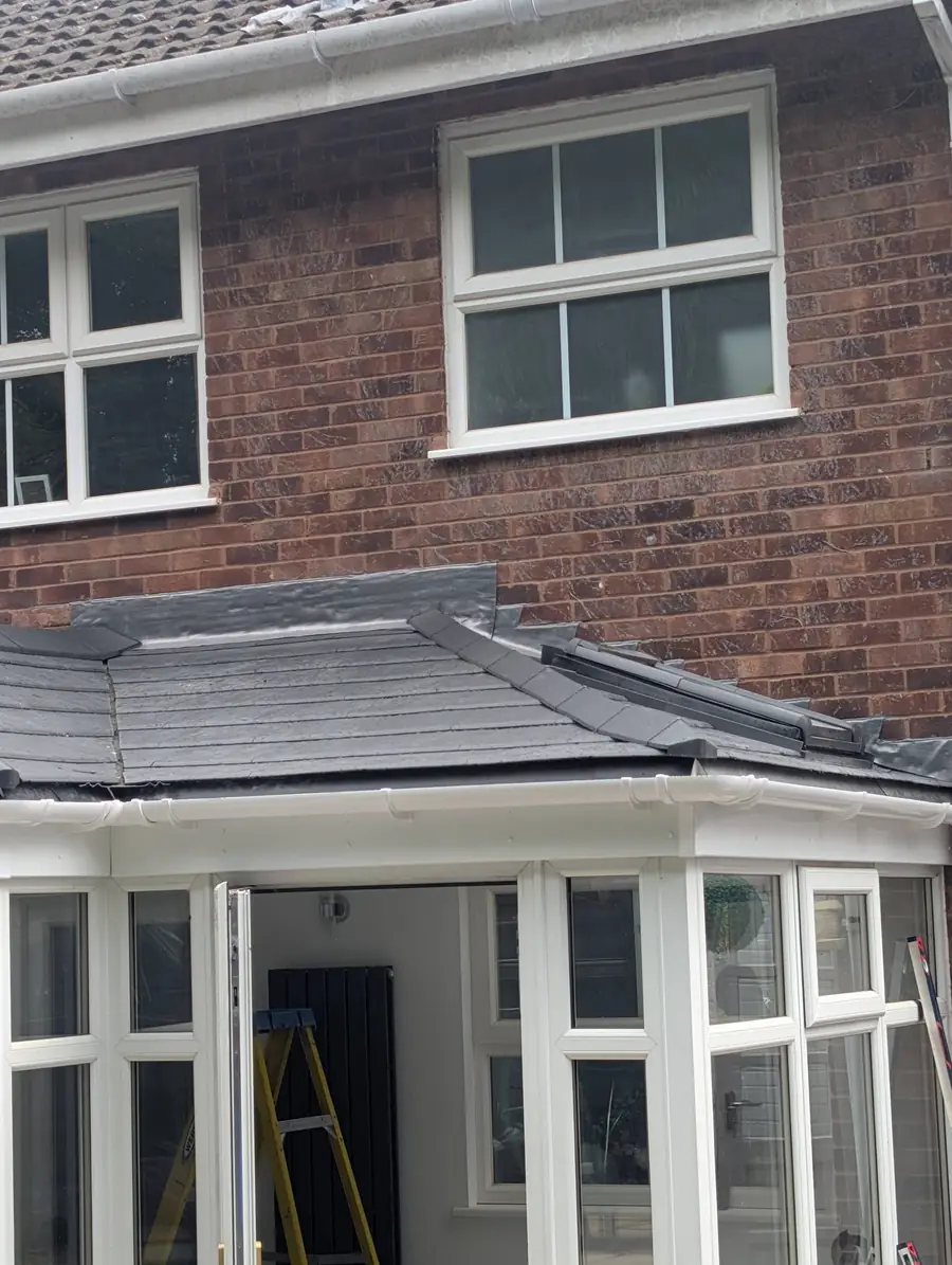 Tiled conservatory roof with new lead flashing to the house wall