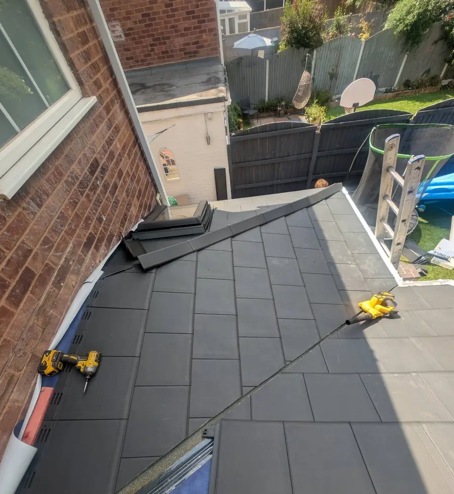 Lightweight roof tiles being laid over a conservatory