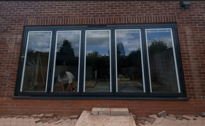 New bi-fold style windows in a brick wall
